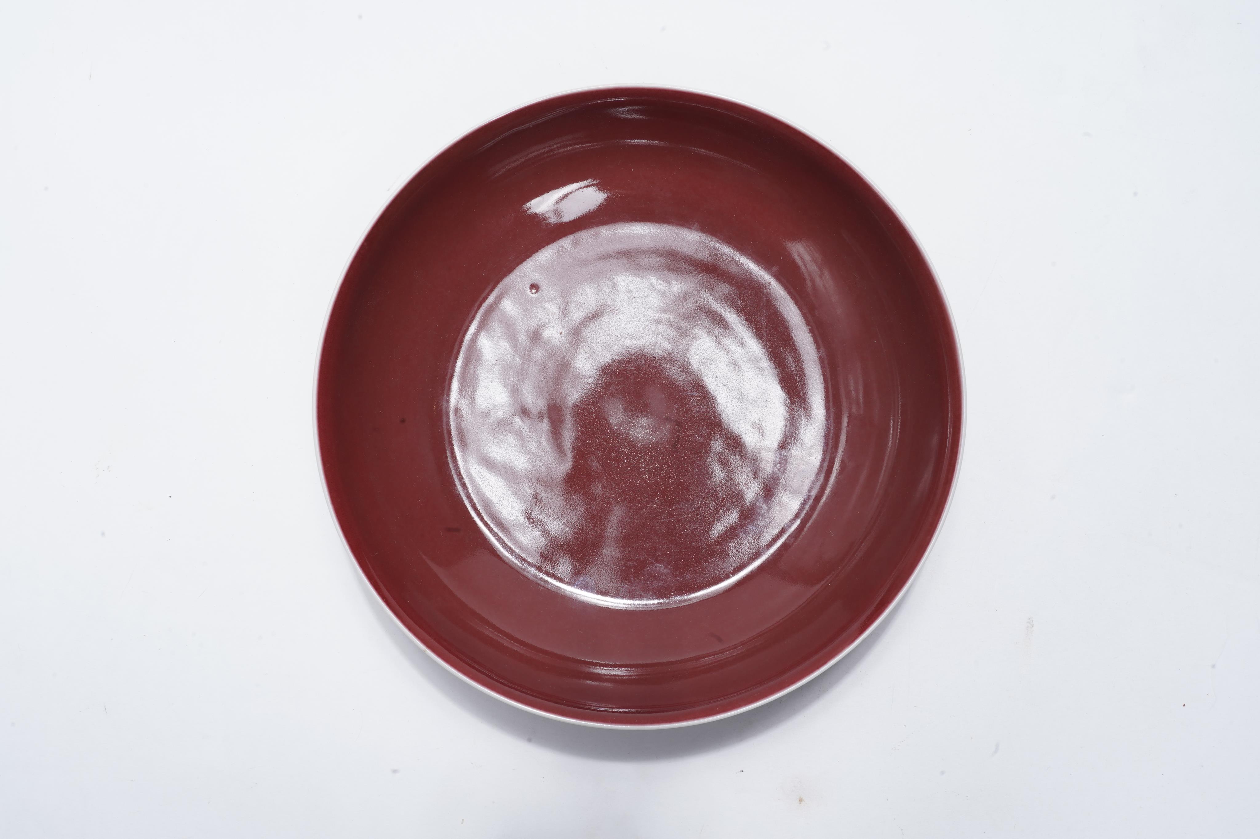 A Chinese copper-red glazed saucer dish, Qianlong six-character seal mark and of the period (1736-95)